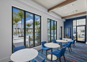 Thumbnail 10 of 78 - a lounge area with tables and chairs and large windows at Altis Blue Lake, Lake Worth, FL, 33467
