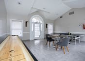 Thumbnail 31 of 44 - a dining area with a table and chairs and a ping pong table in a