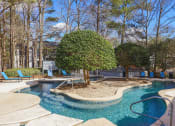 Thumbnail 37 of 44 - a swimming pool with a tree in the middle of it