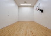 Thumbnail 34 of 44 - a large white room with a basketball hoop on the wall