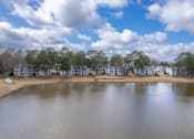 Thumbnail 41 of 44 - the view of a lake with apartments in the background and a cloudy sky