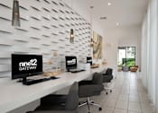 Thumbnail 6 of 42 - A modern office space with white desks and black chairs.