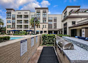 Thumbnail 36 of 42 - A building with a pool and a walkway with signs on it.
