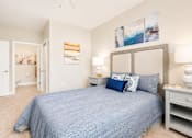 Thumbnail 5 of 31 - A bedroom with a bed, nightstand, and two lamps.