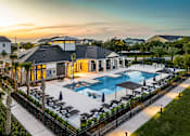 Thumbnail 1 of 45 - A luxurious resort with a swimming pool and lounging area.