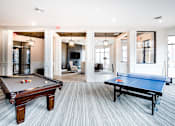 Thumbnail 11 of 53 - A room with a pool table and a ping pong table.