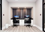 Thumbnail 9 of 53 - A room with two computer desks and chairs.
