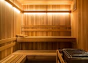 Thumbnail 18 of 53 - A wooden sauna with a bench and a heater.