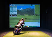 Thumbnail 16 of 53 - A golf simulation game is being played on a screen.