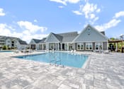 Thumbnail 33 of 48 - A large house with a pool in front.