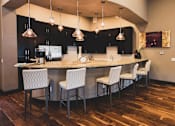 Thumbnail 10 of 18 - a kitchen and dining room with a bar and chairs