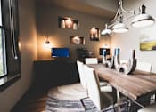 Thumbnail 13 of 18 - a dining room with a wooden table and white chairs