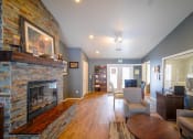 Thumbnail 5 of 43 - a living room with a fireplace and a table
