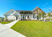 Thumbnail 2 of 23 - A modern house with a white exterior and a black roof.