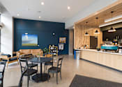 Thumbnail 17 of 33 - A modern dining area with a large screen on the wall.