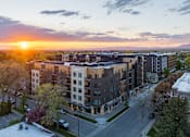Thumbnail 32 of 33 - A sunset view of a residential area with apartment buildings.