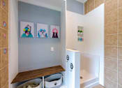 Thumbnail 12 of 28 - A bathroom with a white tub and a wooden bench.