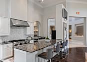 Thumbnail 7 of 25 - Gourmet Kitchen With Island at Orion McCord Park, Little Elm, TX