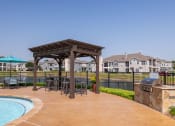 Thumbnail 19 of 33 - a backyard with a pool and patio with chairs and a grill at Orion Prosper, Prosper, TX, 75078