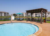 Thumbnail 17 of 33 - a swimming pool with a gazebo next to a resort style pool at Orion Prosper, Prosper, TX, 75078