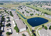 Thumbnail 37 of 38 - A bird's eye view of a residential area with a large lake in the middle.