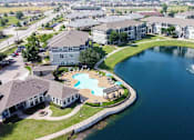 Thumbnail 35 of 38 - A large building with a pool and a pond in front.