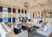 Thumbnail 9 of 23 - a living room with couches and chairs and a table  at Orion Prosper Lakes, Texas, 75078