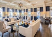 Thumbnail 12 of 23 - a living room with couches and chairs and a table  at Orion Prosper Lakes, Texas