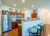 Thumbnail 2 of 33 - a kitchen with a breakfast bar and stainless steel appliances  at Orion Prosper, Prosper