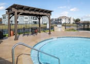 Thumbnail 22 of 33 - a resort style pool with a gazebo and a table and chairs next  at Orion Prosper, Prosper, TX