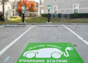 Thumbnail 27 of 33 - an electric vehicle charging station in a parking lot  at Orion Prosper, Texas, 75078