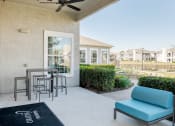 Thumbnail 15 of 33 - a patio with a table and chairs in front of a house at Orion Prosper, Prosper, TX, 75078