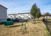 Thumbnail 15 of 26 - a park with a grassy area and houses in the background