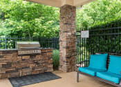 Thumbnail 18 of 29 - a patio with blue chairs and a grill and a bench