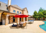 Thumbnail 52 of 69 - a backyard with a pool and a patio with tables and an umbrella