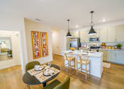 Thumbnail 6 of 40 - a kitchen and dining room with an island and a table and chairs