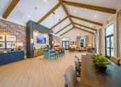 Thumbnail 18 of 40 - the lobby of a clubhouse with a dining room table and chairs
