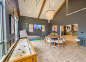 Thumbnail 19 of 40 - game room with skee ball, shuffleboard, a card table, and multi-cade arcade games