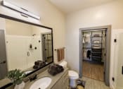 Thumbnail 11 of 46 - A bathroom with a toilet, sink, and mirror.