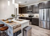 Thumbnail 1 of 50 - Kitchen and dining at Icon Apartment Homes at Ferguson Farm, Montana, 59718