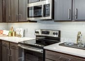 Thumbnail 2 of 50 - Kitchen at Icon Apartment Homes at Ferguson Farm, Montana, 59718
