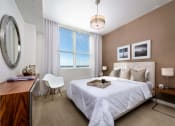 Thumbnail 11 of 14 - a bedroom with a bed and a desk with a chair at Regatta at New River, Fort Lauderdale, 33301
