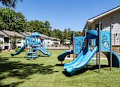 Thumbnail 33 of 33 - A playground with a blue slide and a climbing frame.