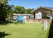 Thumbnail 25 of 33 - A soccer ball is in front of a goal on a green field.
