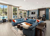 Thumbnail 1 of 33 - A modern living room with a large blue sectional sofa and a television.