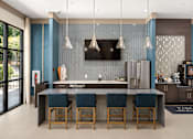 Thumbnail 2 of 33 - A modern kitchen with a dark blue backsplash and a central island.