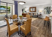 Thumbnail 13 of 33 - A dining room with a glass table surrounded by chairs.