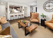 Thumbnail 9 of 33 - A living room with a brown leather chair and a wooden coffee table.