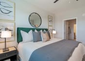 Thumbnail 24 of 43 - 1-Bedroom Apartments in Madison, AL - Paxton Place - Spacious Bedroom with Plush Carpet, Bed, Nightstands with Lamps, Mirror, and Spacious Closet.
