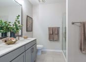 Thumbnail 28 of 43 - a bathroom with a sink and a shower and a toilet